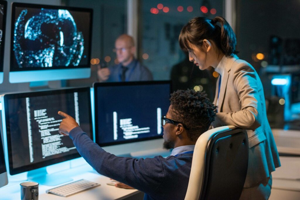 AI for Credit Unions: Unlocking Member Loyalty Through Personalization 3 Marketing and IT professionals analyzing member data with AI-powered dashboards in a credit union office
