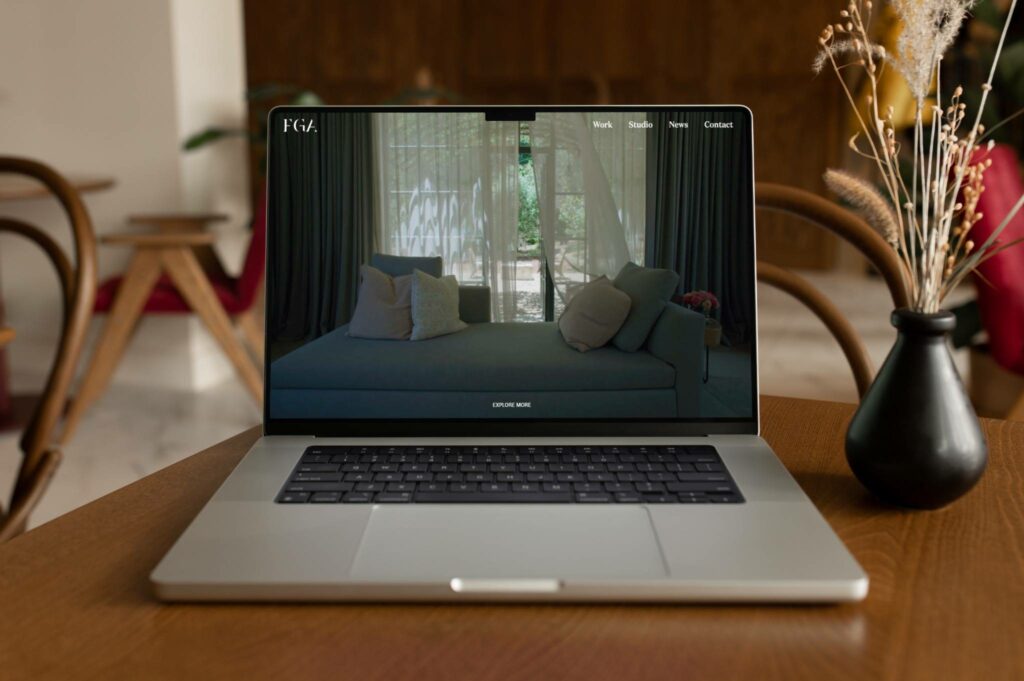Laptop showing a consumer-focused website with elegant interior design, representing B2C web design services by Jives Media