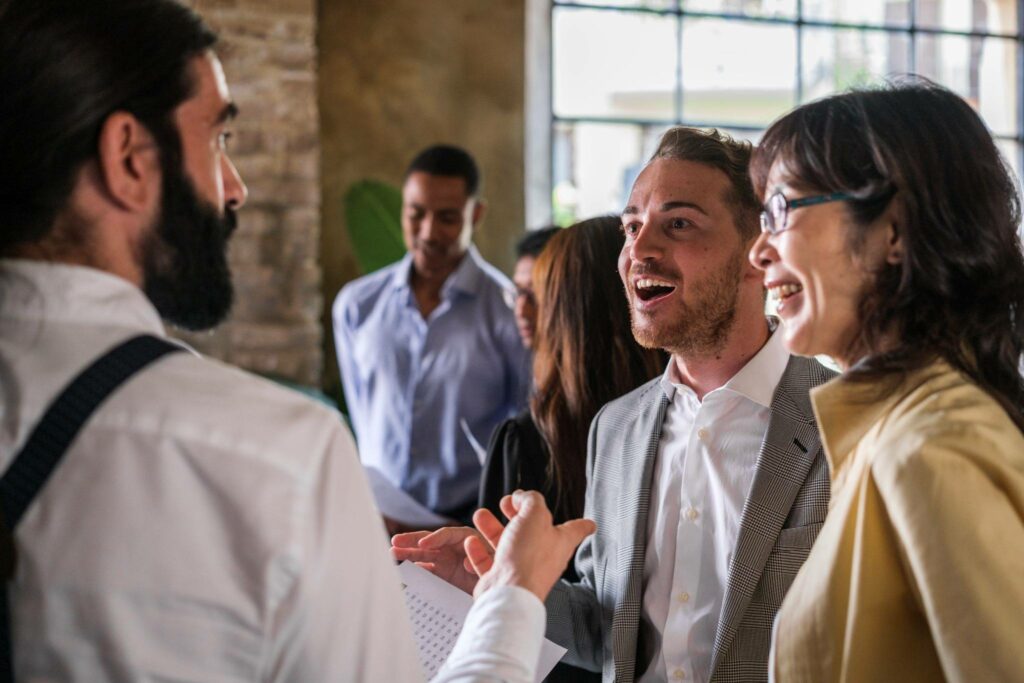 AI for Credit Unions: Unlocking Member Loyalty Through Personalization 5 Credit union members and staff engaging in a lively conversation during a member-focused networking event